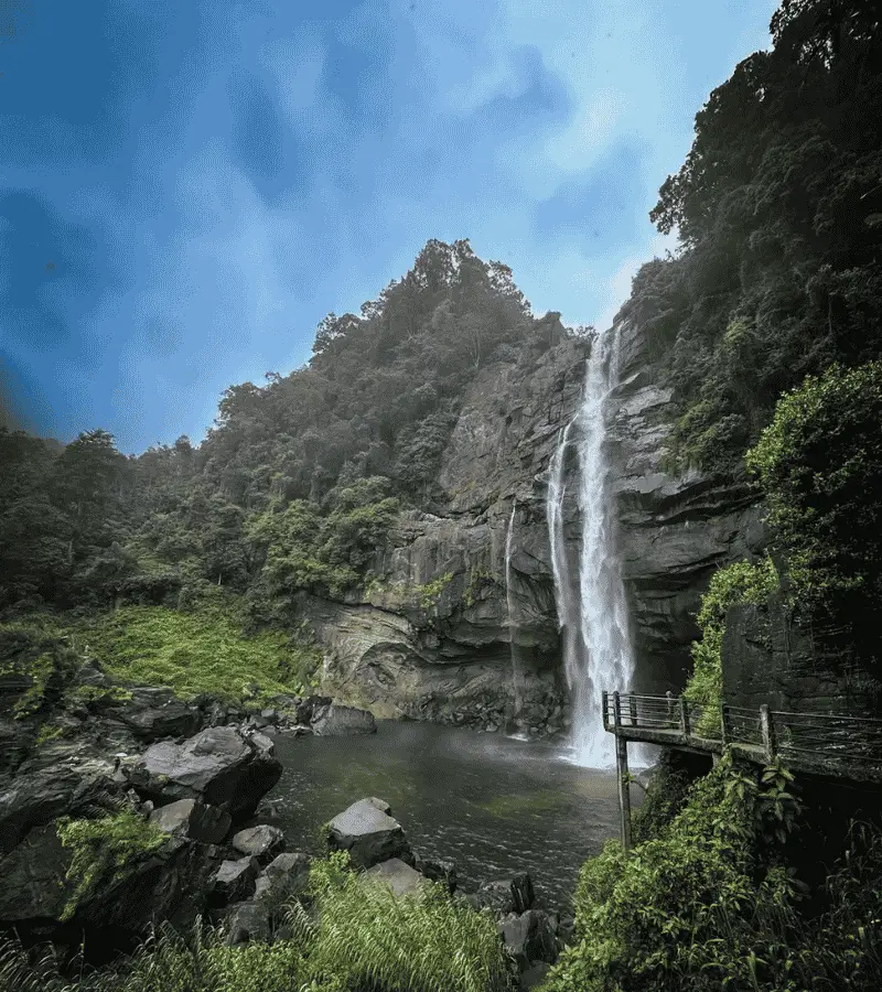 Waterfalls in Sri Lanka's hill country — Laxapana Falls drops through tea-covered mountains and forest near Hatton